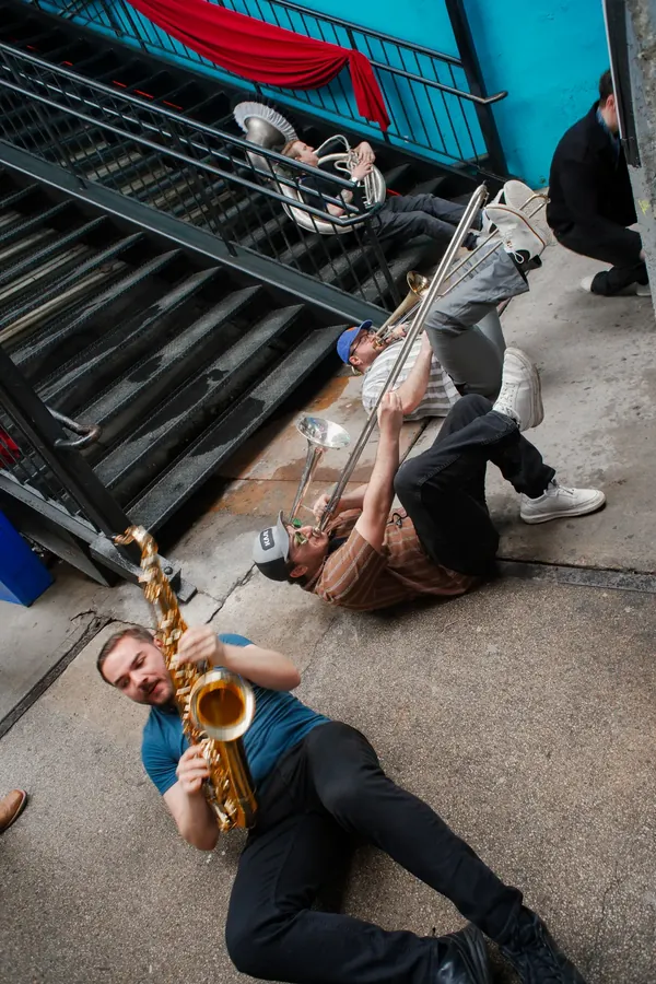 Brass band sprawled across the stairs outside Elsewhere